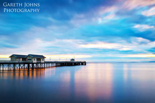 Colourful long exposure of Penarth Pier at sunrise