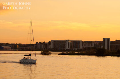 Sunset over Cardiff Bay with boat
